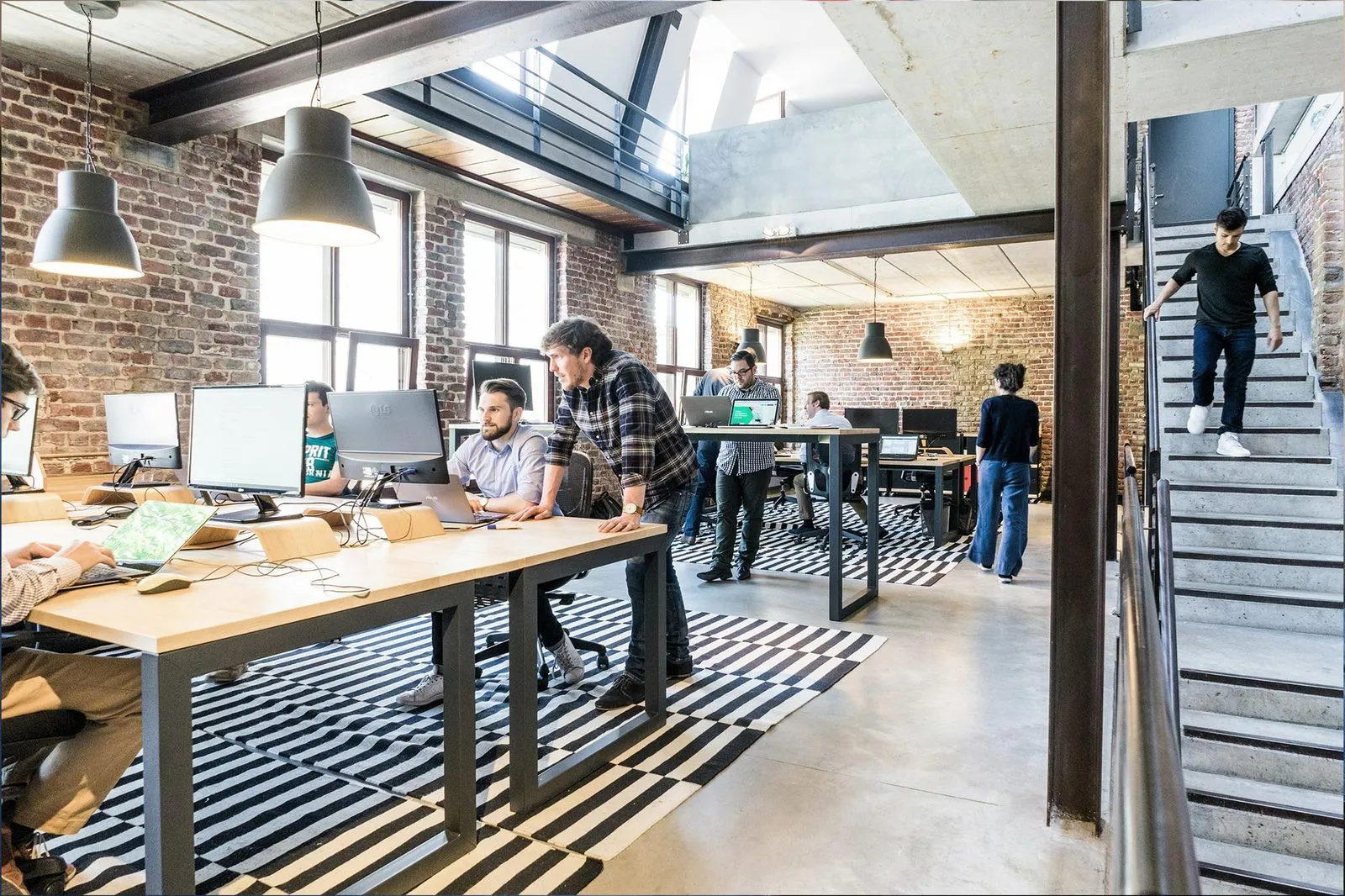 Coworkers at their desks in an open-plan office
